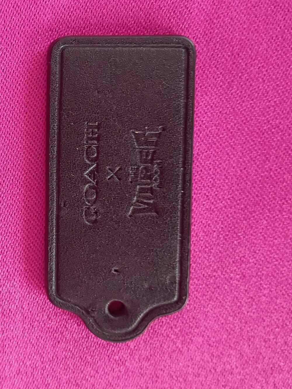 Coach Black Leather Tag with Pink Backdrop Accent